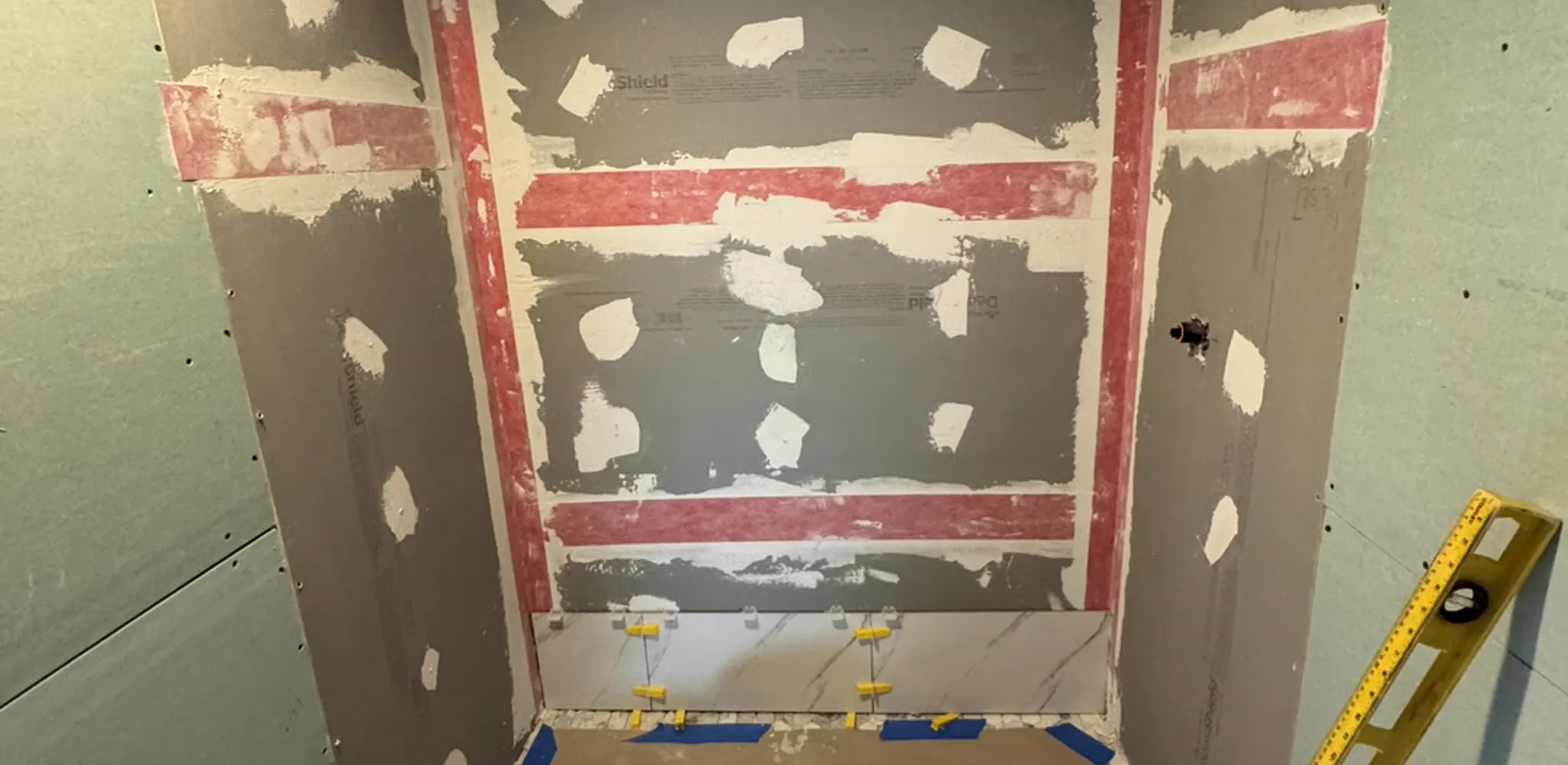 Shower walls in waterproofing membrane before any tile goes on