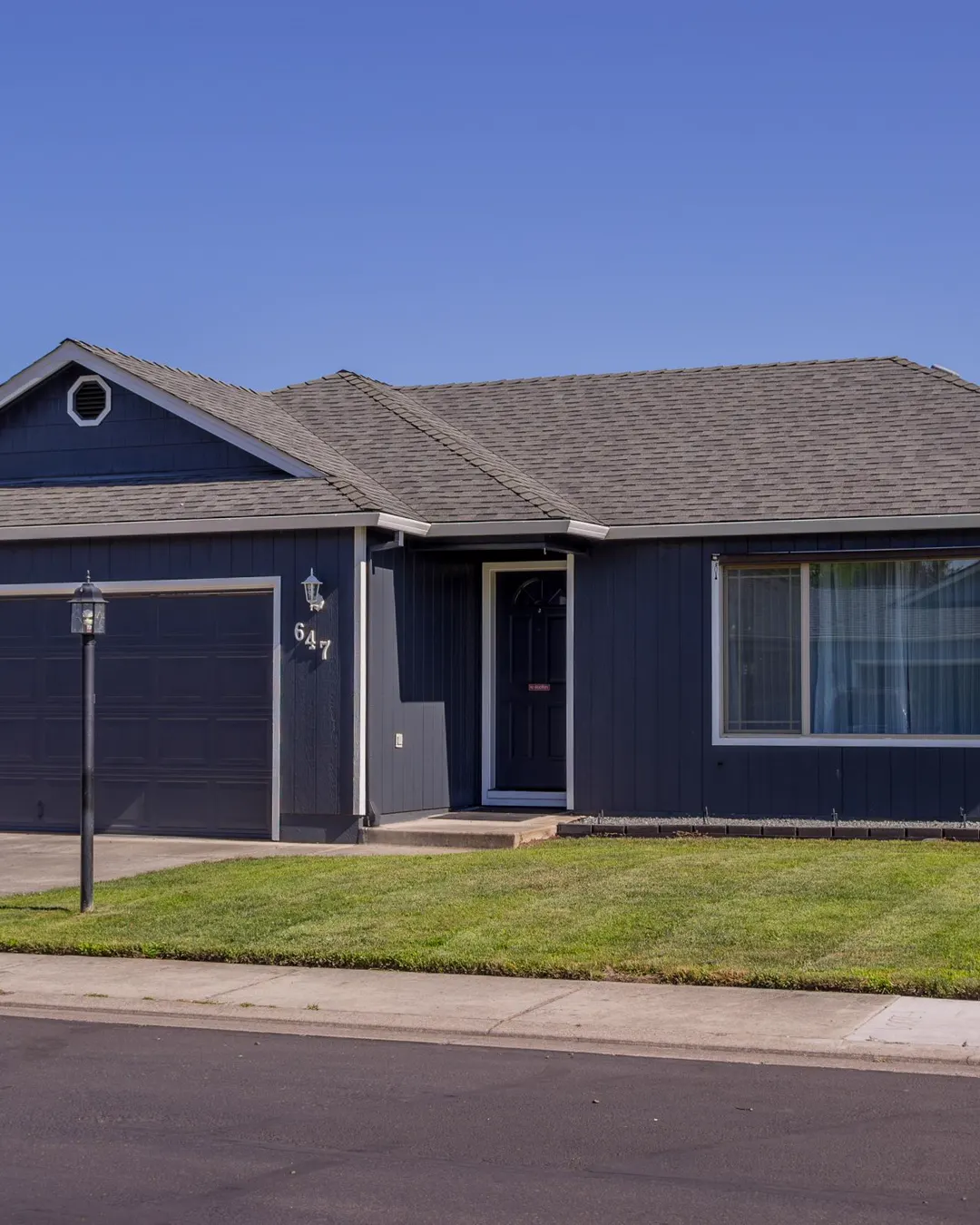A single story house with a driveway and a lawn, the kind of home Maplex Services remodels