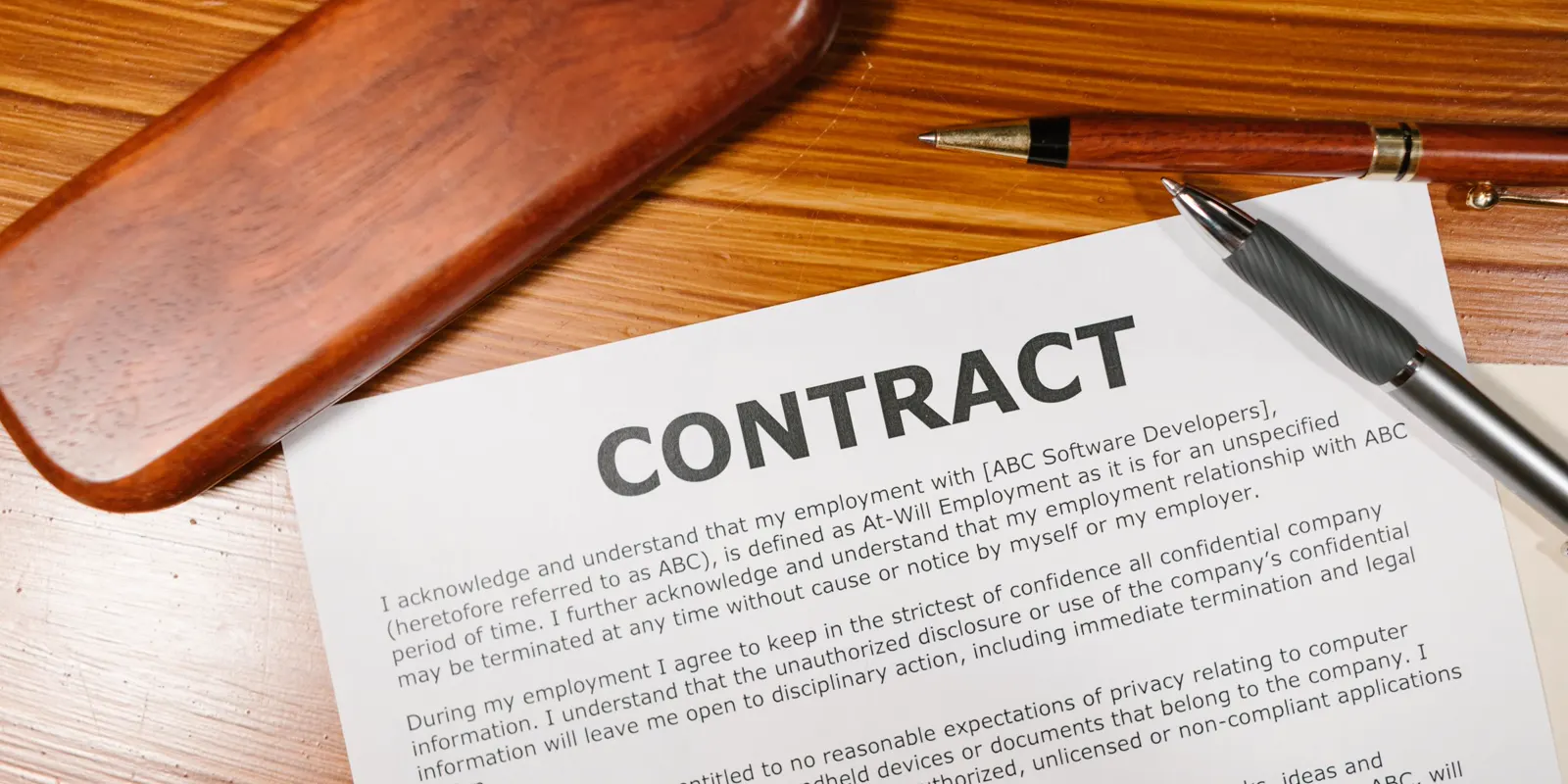 A printed contract and a pen resting on a wooden desk, the rights Florida law gives a homeowner