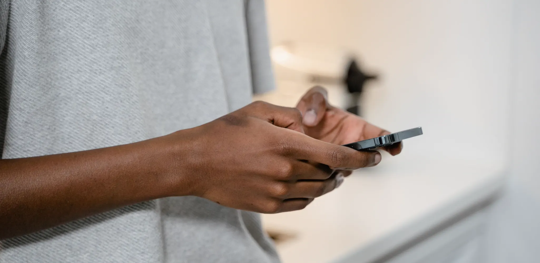 Two hands typing a message on a smartphone, the privacy policy of Maplex Services