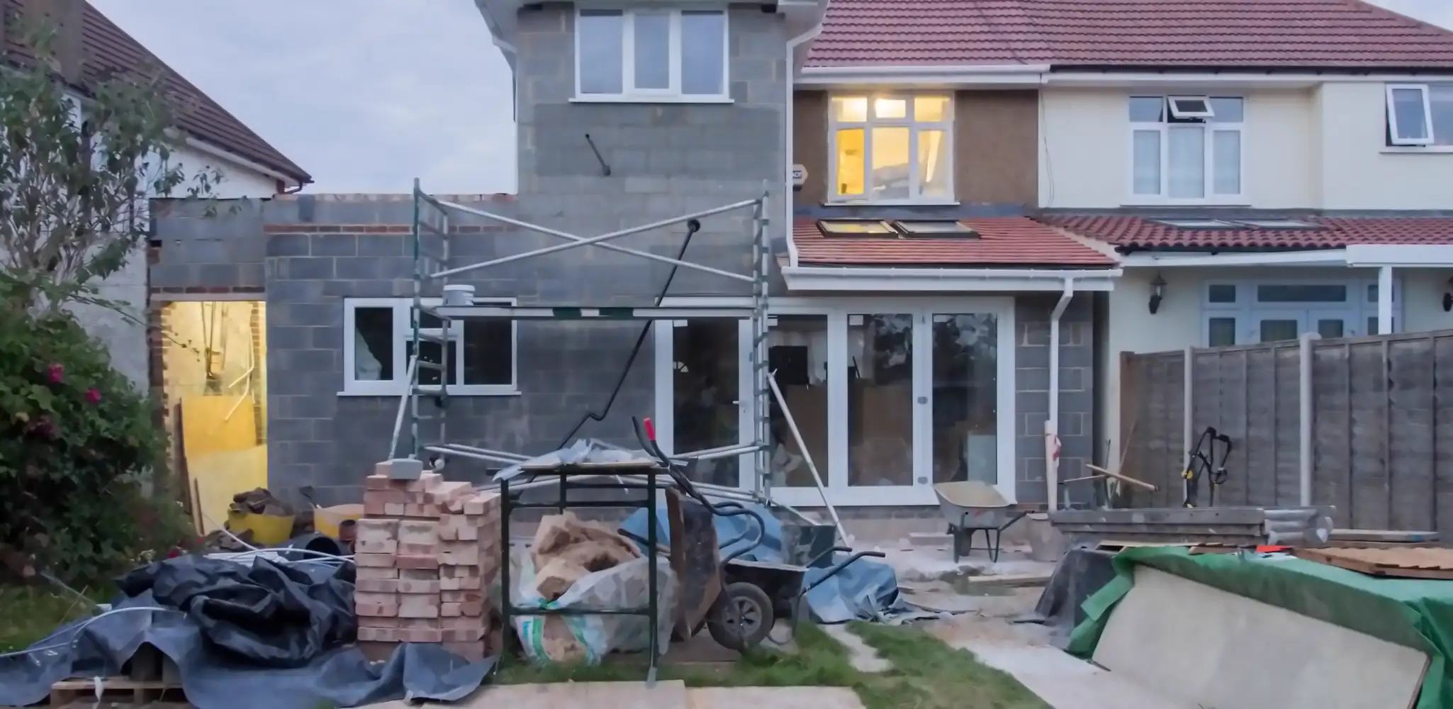 A house with scaffolding during a large renovation, home additions