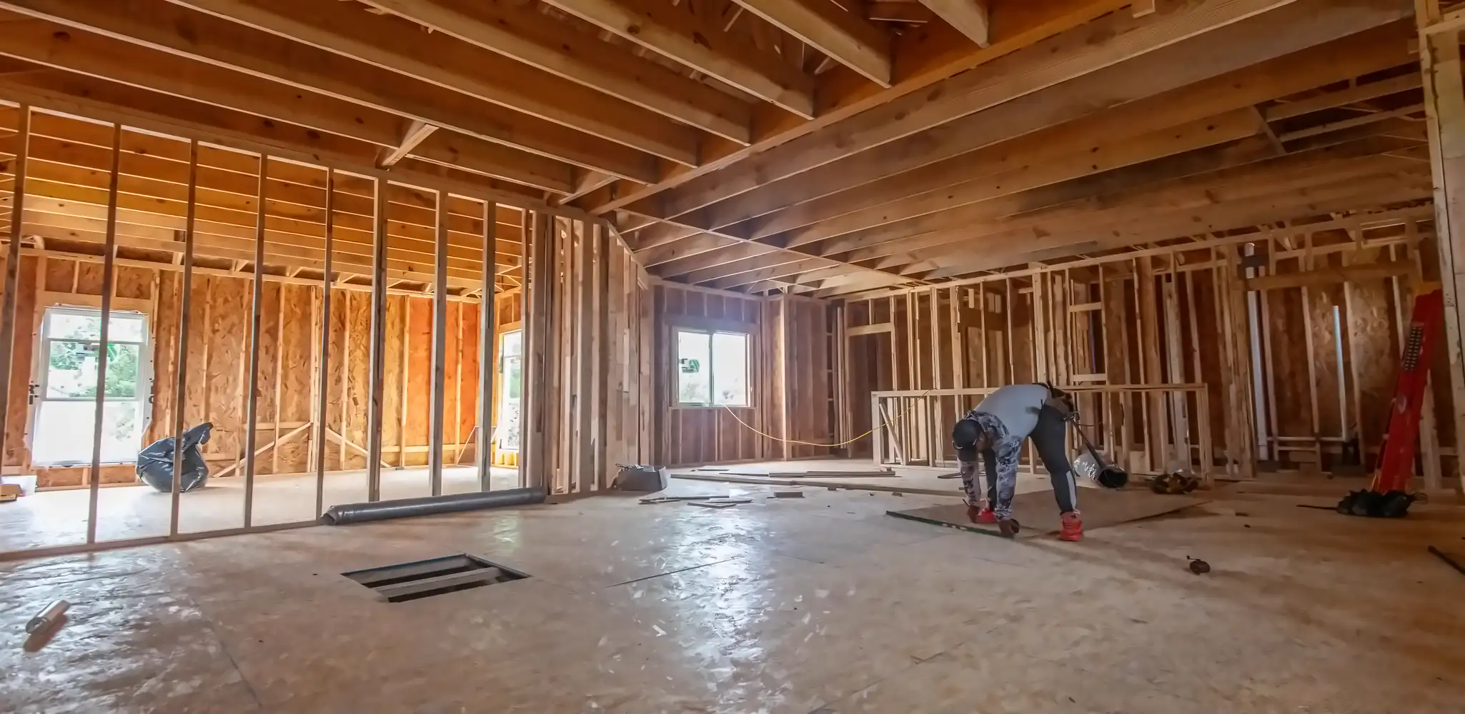 The inside of a house under construction, studs exposed, home additions