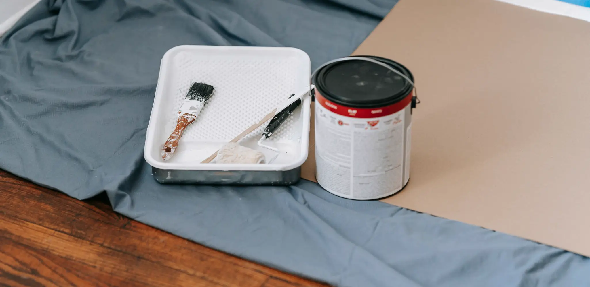 Painting tools and materials laid out for a room, interior and exterior painting