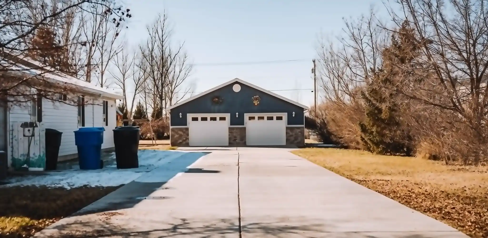 A driveway leading to a garage in a quiet neighborhood, driveways