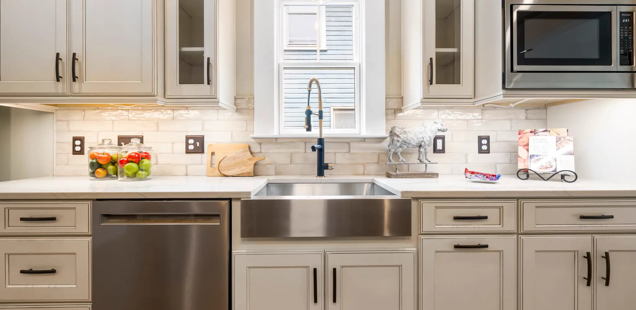 A farmhouse sink set into new kitchen cabinets, cabinet installation