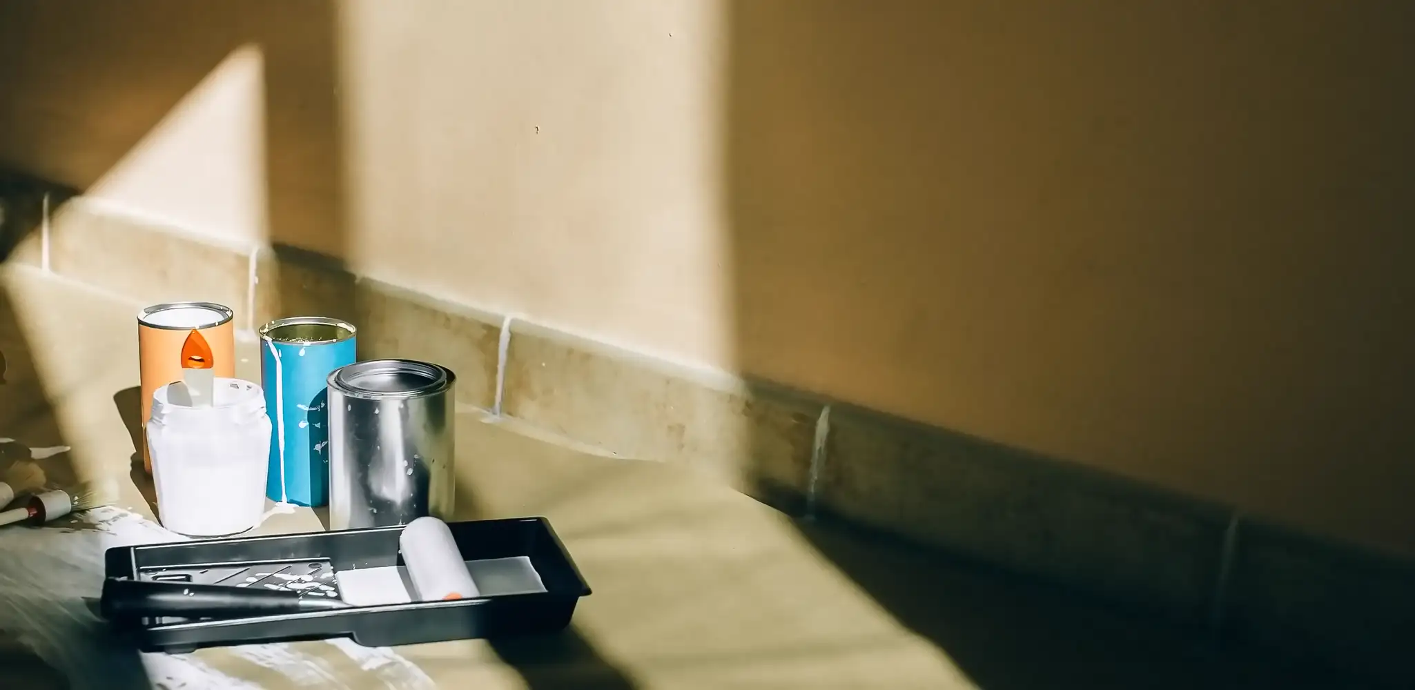 Painting tools in a bright corner of a room, interior and exterior painting
