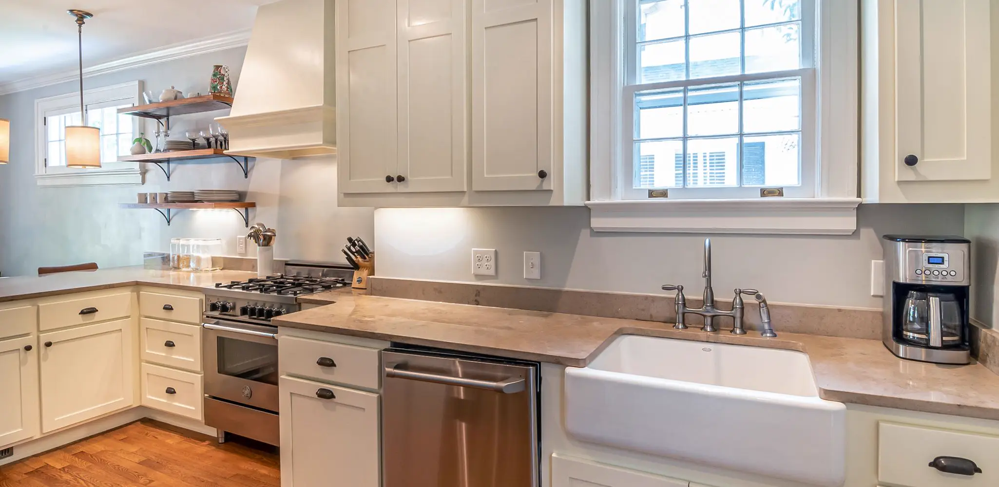 White cabinets in a kitchen with wood floors, cabinet installation