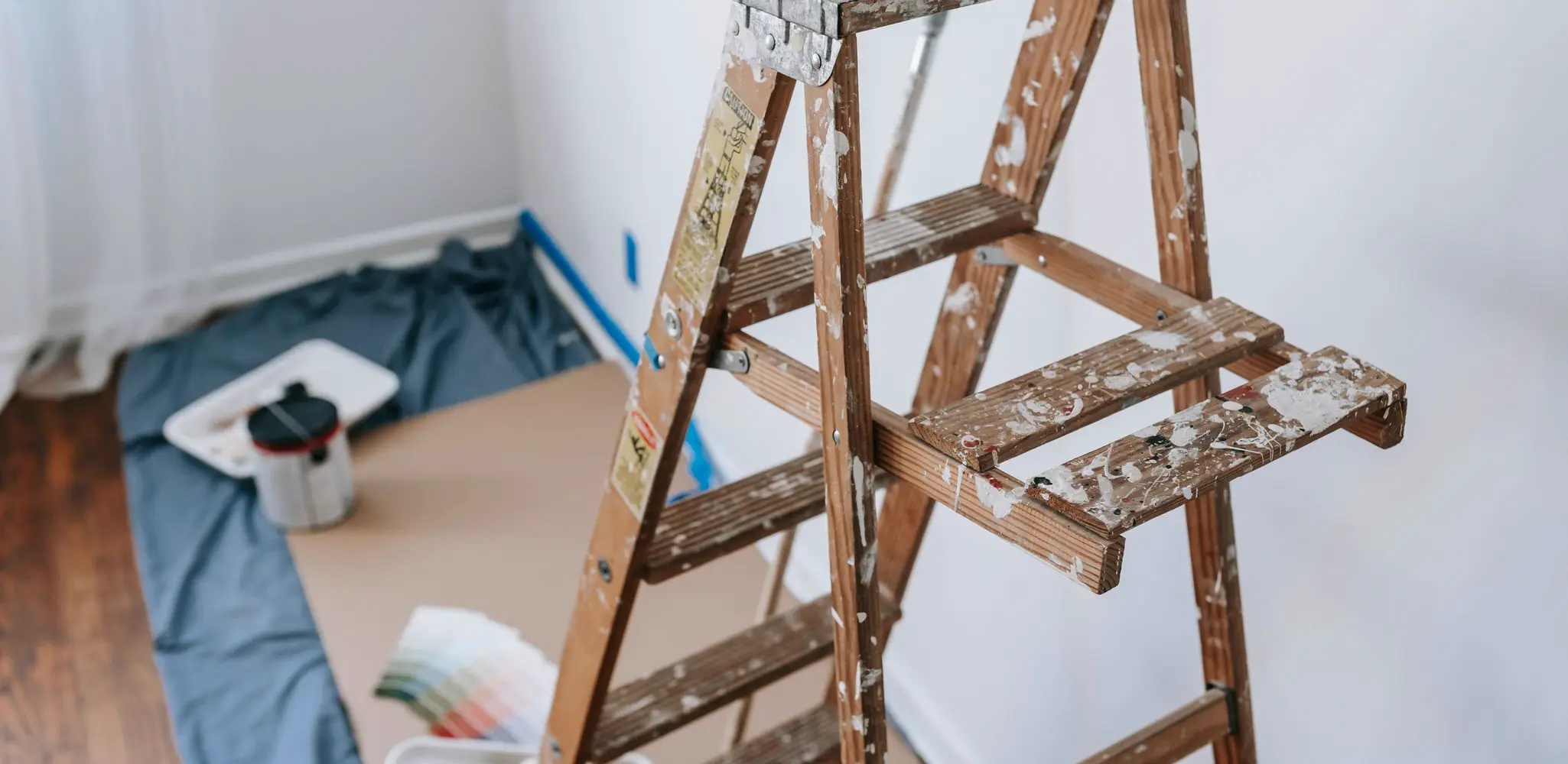 A stepladder and painting tools set up in a room, interior and exterior painting