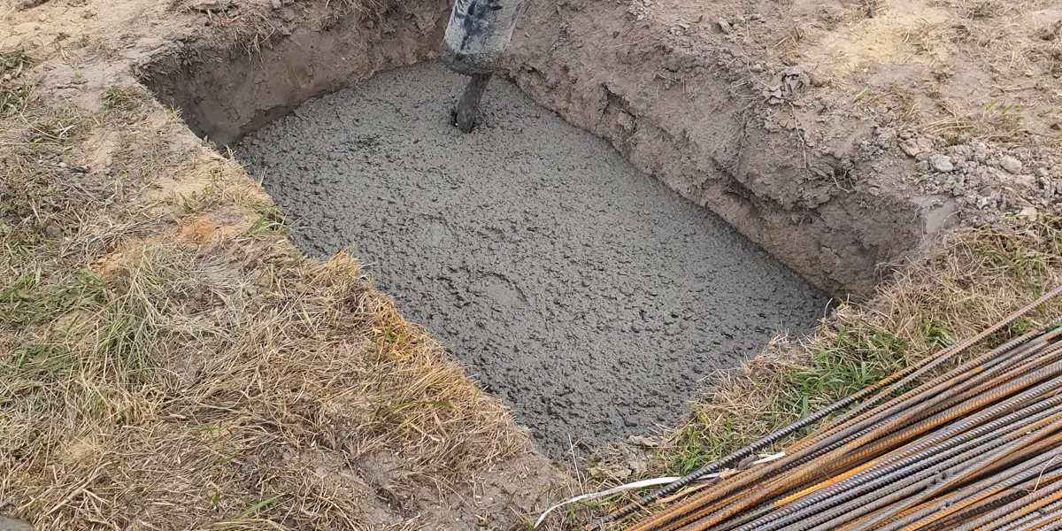 Concrete being poured into a formed foundation, concrete driveway replacement
