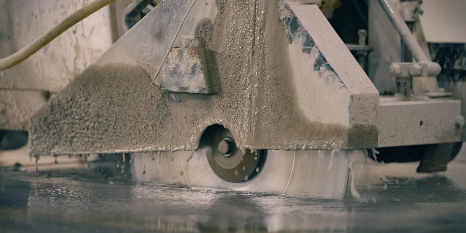 Close up of a concrete saw cutting a control joint in a slab, concrete driveway replacement