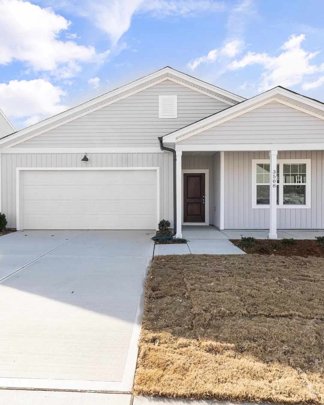 A new one story house with a fresh concrete driveway, concrete driveway replacement