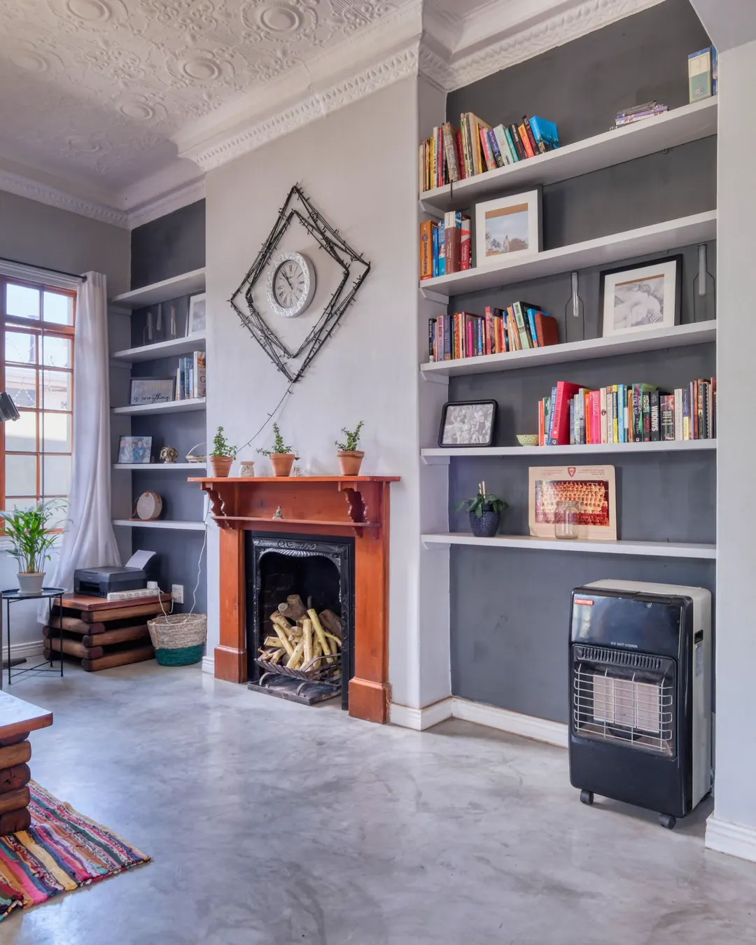 A living room with a fireplace flanked by built-in bookshelves, custom built-ins