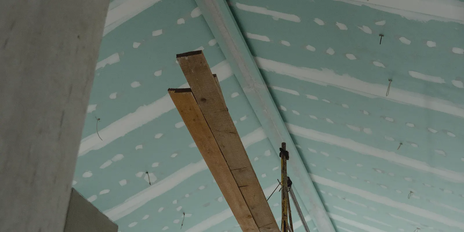 Scaffolding set up under a ceiling of new drywall, drywall repair