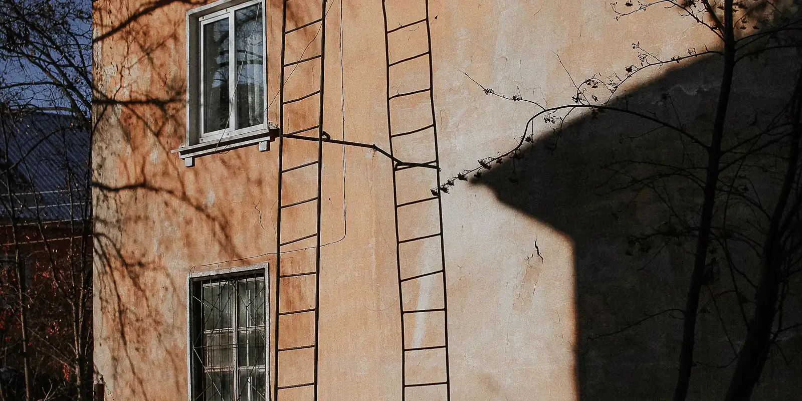 A ladder leaning against the wall of a house before work starts, exterior remodel cost