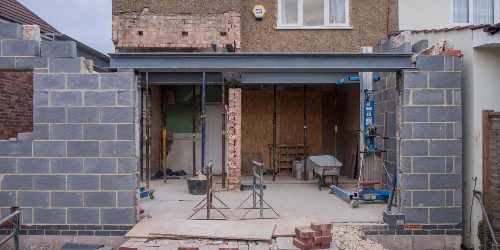 A brick house under renovation with the front opened up, front of house remodel