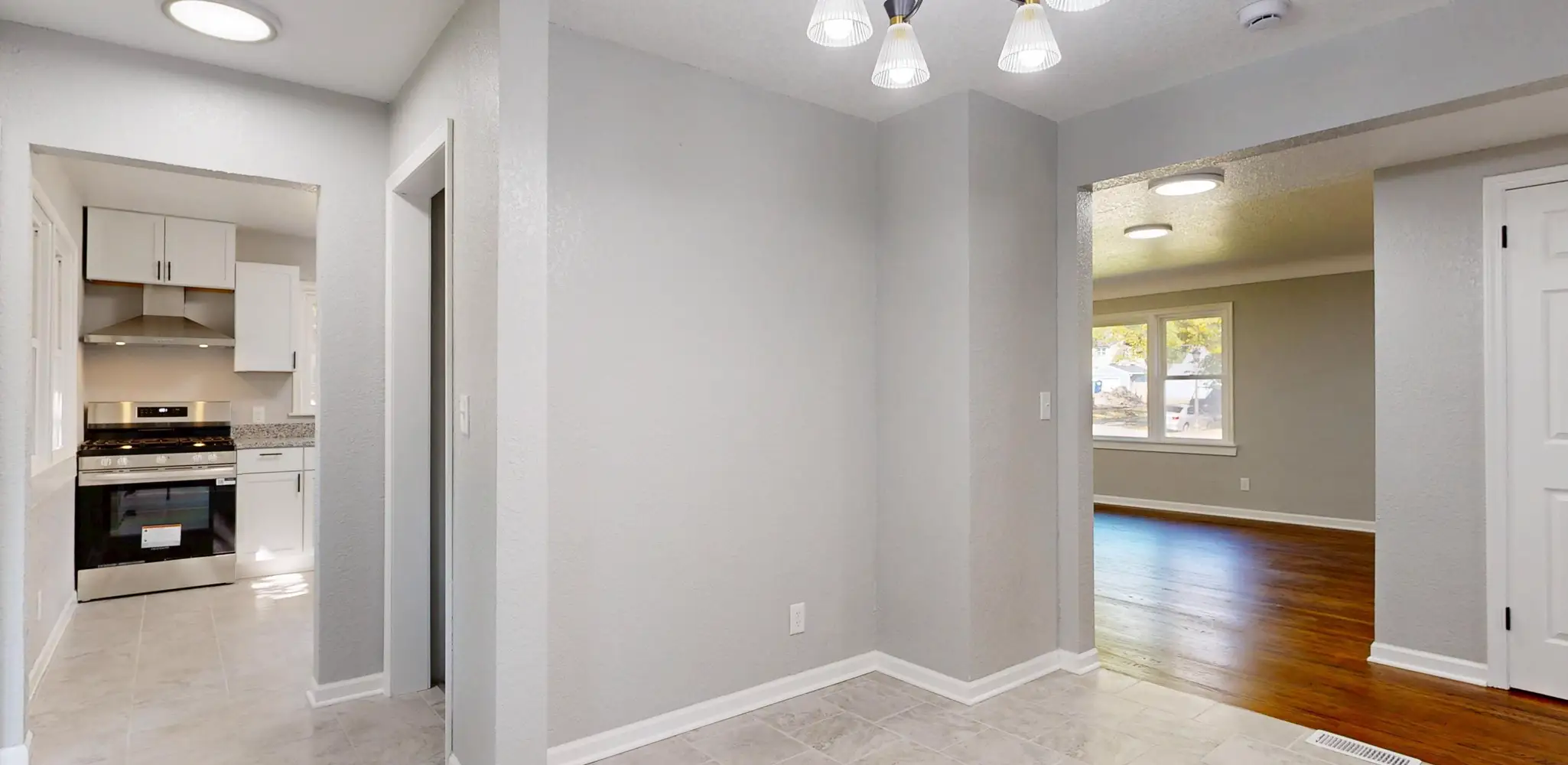 A renovated room with gray walls, new lighting and clean trim, home remodel cost