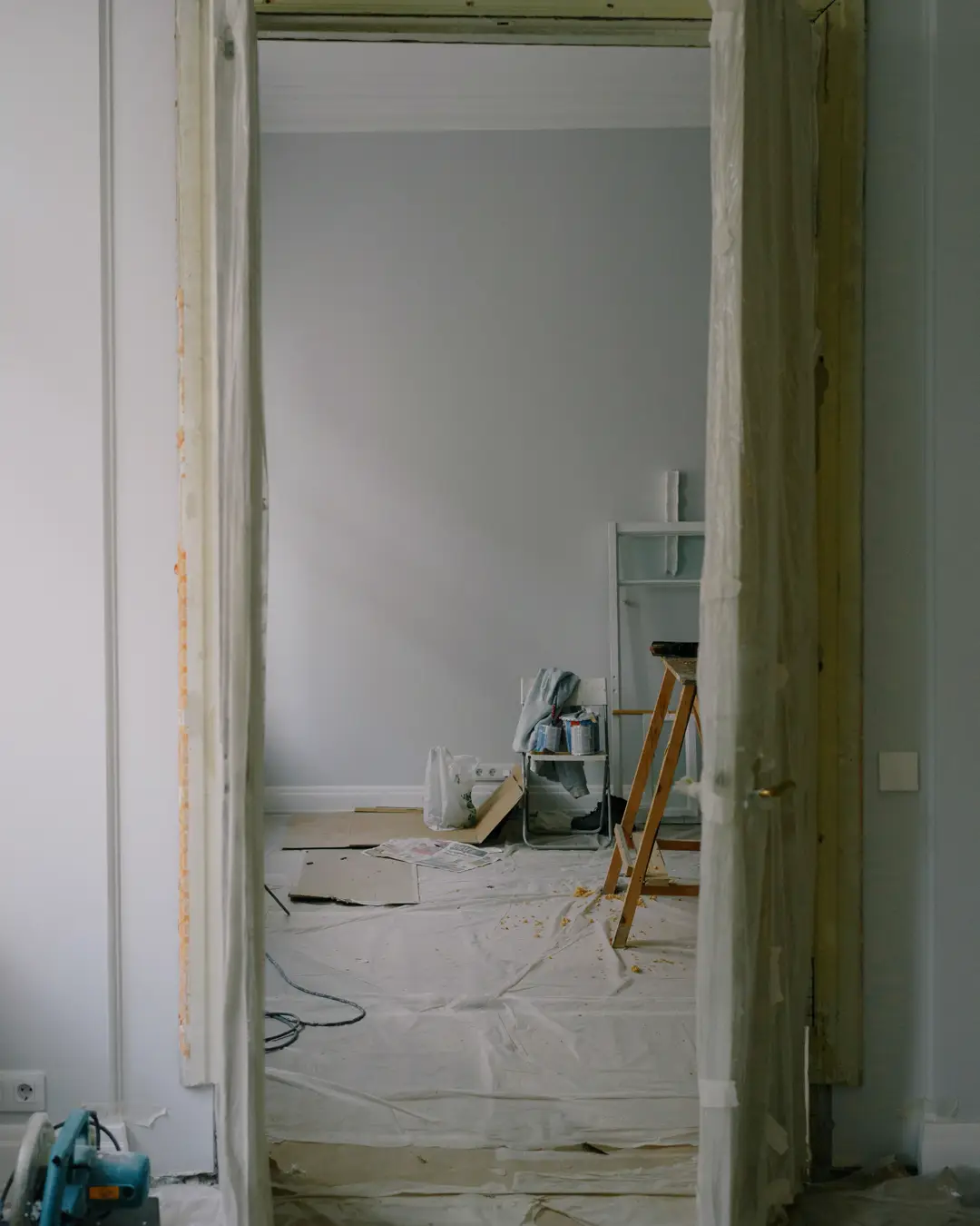 A doorway in a home during renovation with tools on the floor, home remodel cost