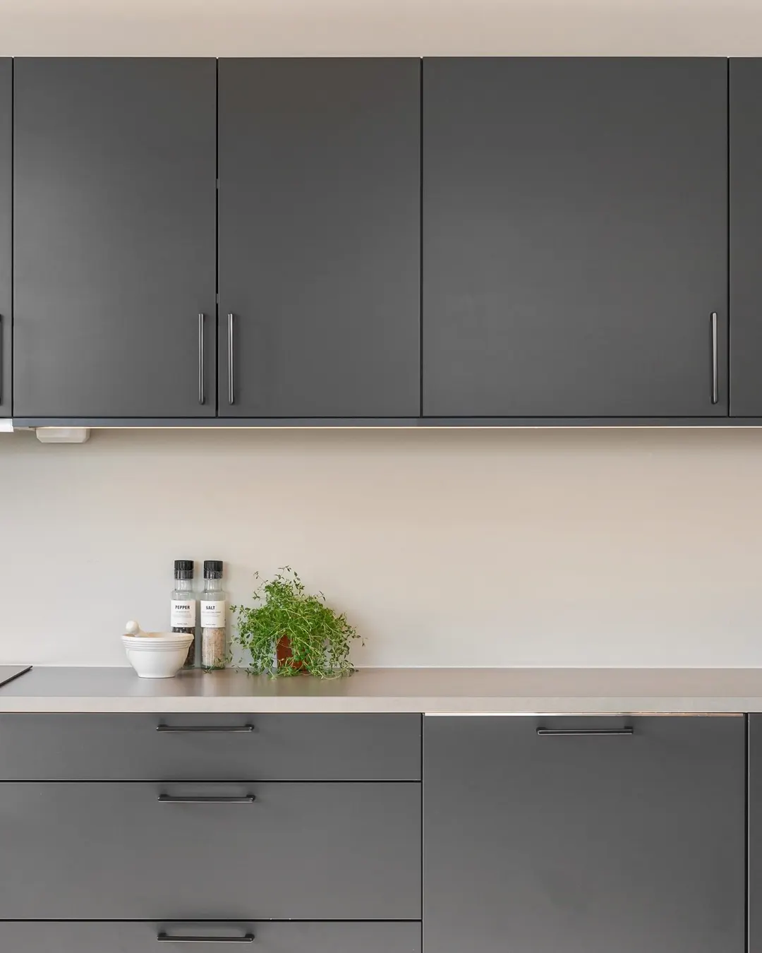 Gray flat panel cabinet fronts with a stone counter, kitchen cabinet refacing