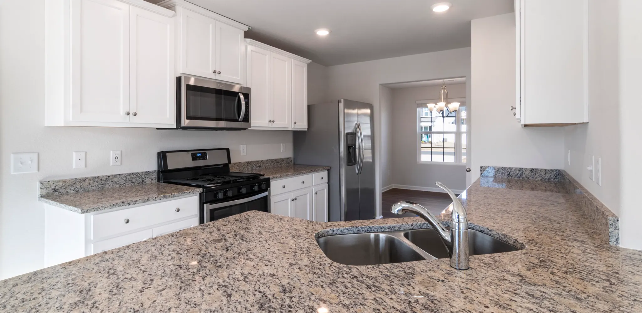 Granite counter and undermount sink on white cabinets, kitchen countertop installation