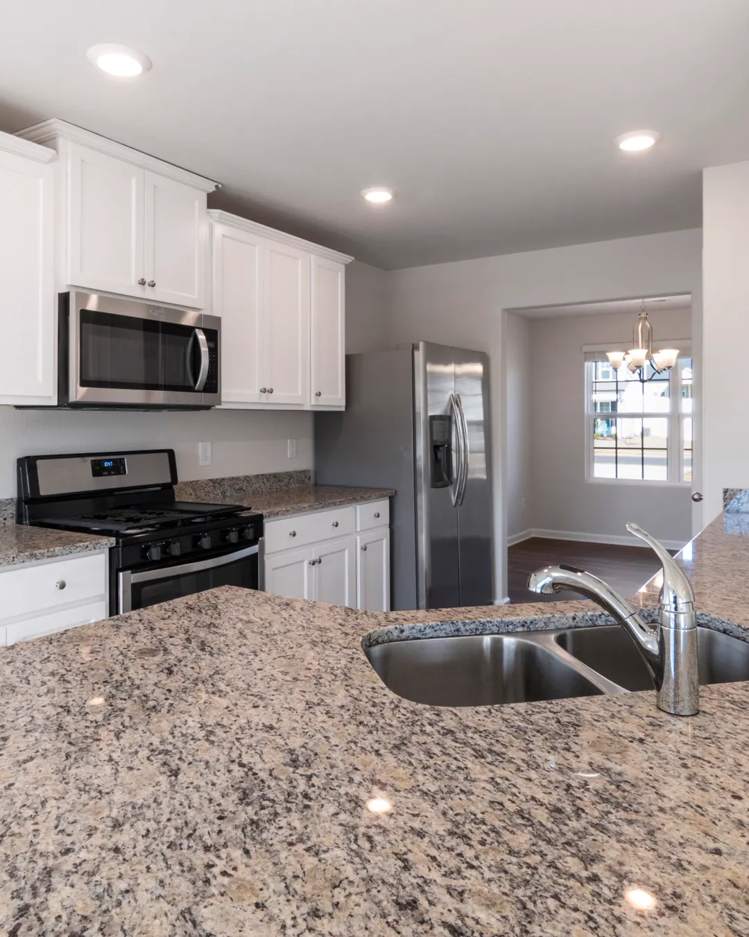 Granite countertop with an undermount sink on white cabinets, countertop installation