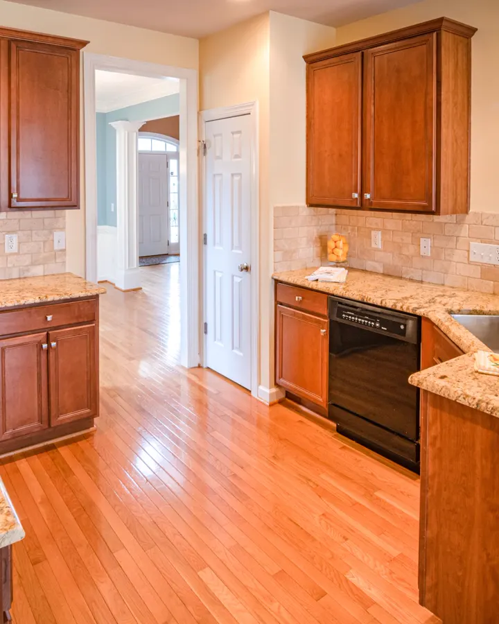 An older kitchen with oak cabinets and tile counters, the point where refacing or replacing gets decided