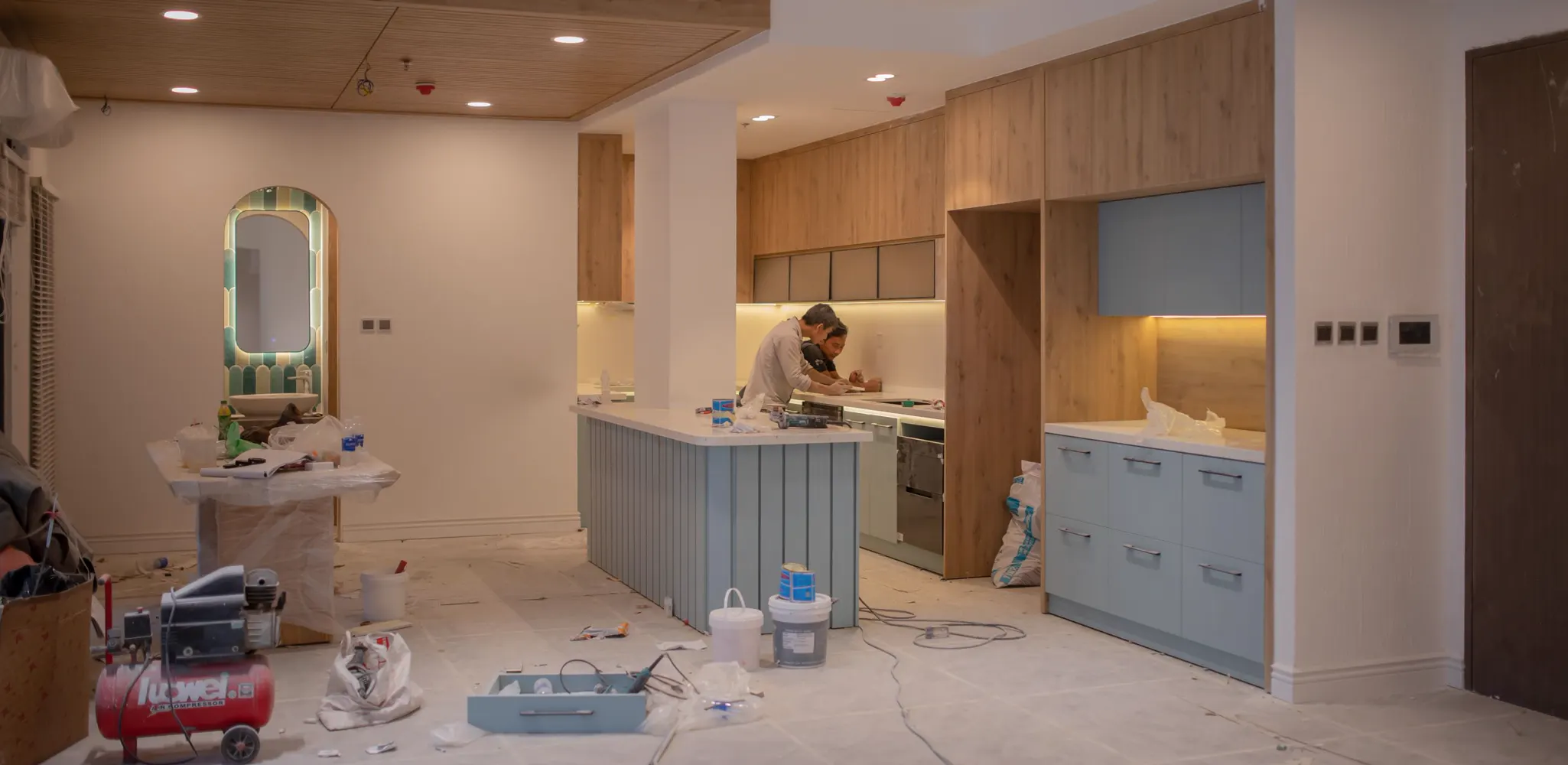 A kitchen under renovation with a new island and cabinets going in, kitchen remodel cost