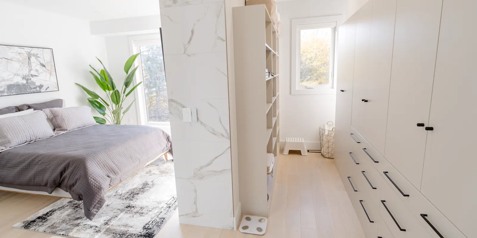 A bright bedroom with a walk-in closet in a minimalist design, master suite addition