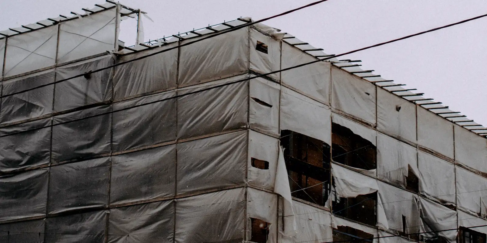 A building wrapped in house wrap before the siding goes on, siding repair