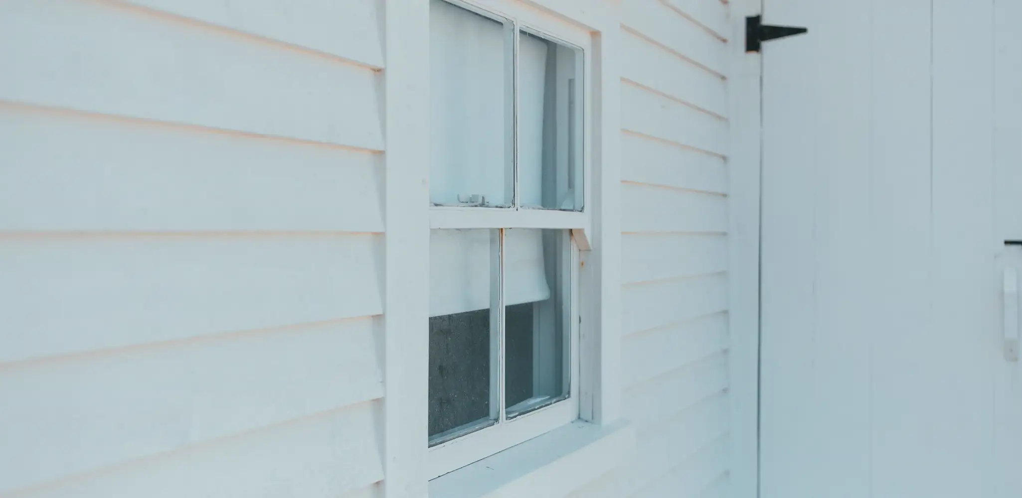 Close up of white lap siding on a house wall, siding repair